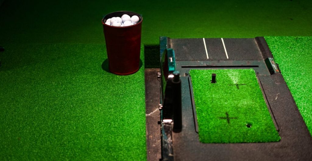 Golf simulator with driving matts and a bucket of golf balls