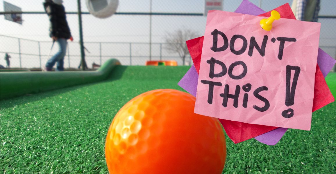 Orange mini-golf golf ball with a don't do it sign in the corner