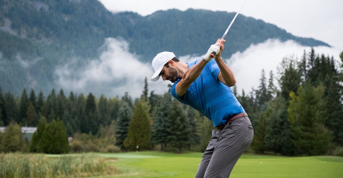 Golfer who is trying to get good at golf fast wearing blue