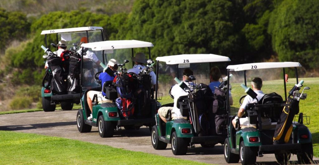 Group of golfers playing 9 holes faster than usual because of their golf carts
